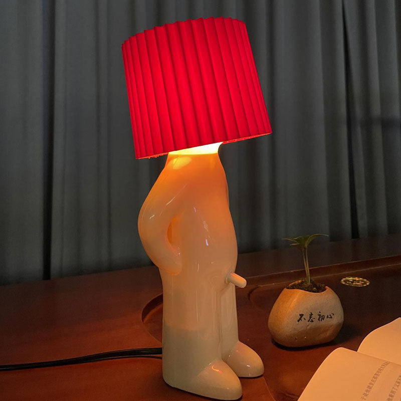 Shy little boy reading lamp